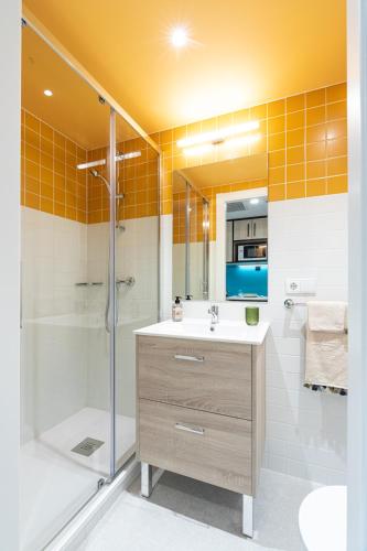 a bathroom with a shower and a sink and a tub at Micampus Salamanca Student Residence in Salamanca
