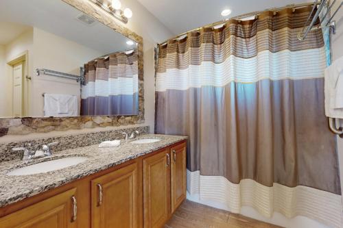 a bathroom with a sink and a shower at Keepin' it Reel in Pensacola Beach