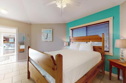 a bedroom with a large bed and a window at Keepin' it Reel in Pensacola Beach