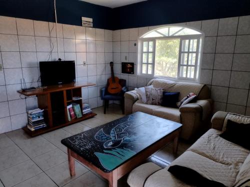 a living room with a couch and a coffee table at Hostel Da Ilha De Sao Francisco Do Sul in Marechal Luz