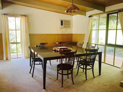 a dining room with a table and chairs at Rivendell Cottage in Steels Creek