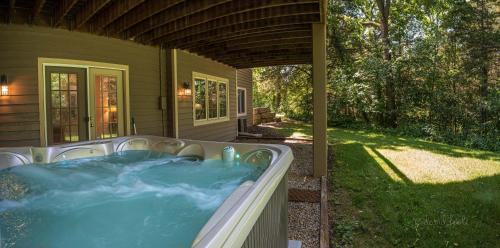 a hot tub on the side of a house at The Lodge, 'North Woods' style, boutique Galena Getaway! in Galena