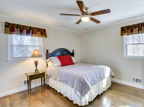 a bedroom with a bed and a ceiling fan at Lake Hartwell Retreat with Deck and Private Dock! in Anderson