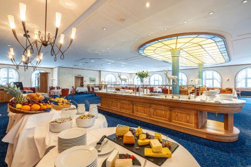 a hotel lobby with tables with food on them at Central Sporthotel Davos in Davos