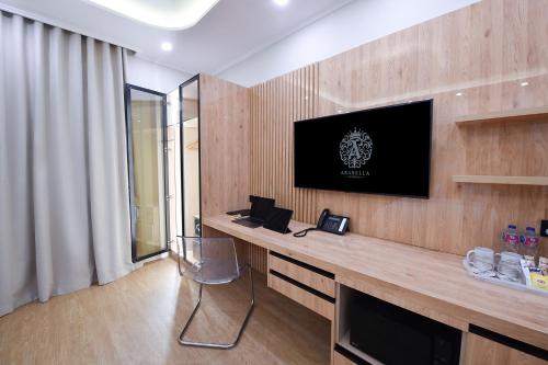 a living room with a television on a wooden wall at Arabella Premium Residence - New Cairo in Cairo