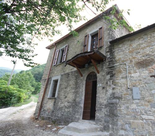 an old stone building with a window and a door at Agriturismo Cà Sonino in Bettola