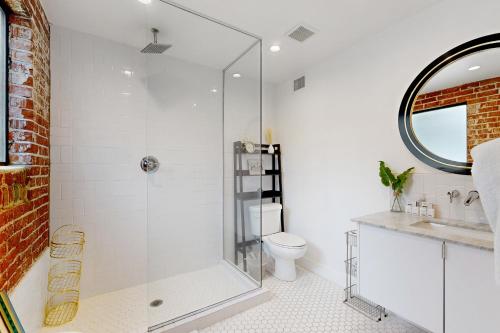 a bathroom with a glass shower and a toilet at Encanto Dreams in Phoenix
