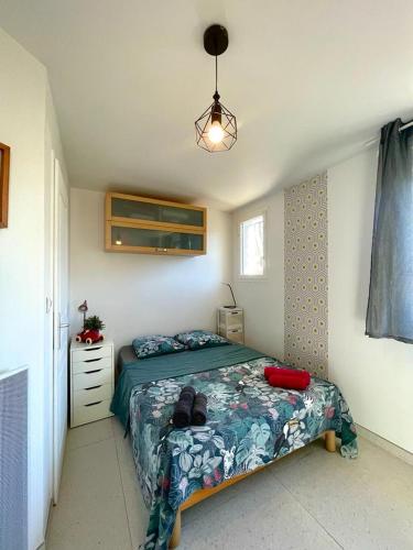 - une petite chambre avec un lit et une lampe dans l'établissement Studio dans la Villa les Cigales, à Lézignan-Corbières