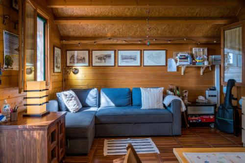 a living room with a blue couch in a room at Casetta Pizziddu in San Giovanni Gemini