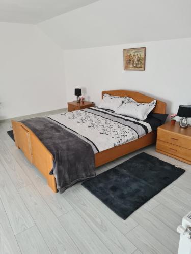 a bedroom with a large bed and a rug at Margareta's House - Free Parking, Garden, Near Sibiu in Sibiu