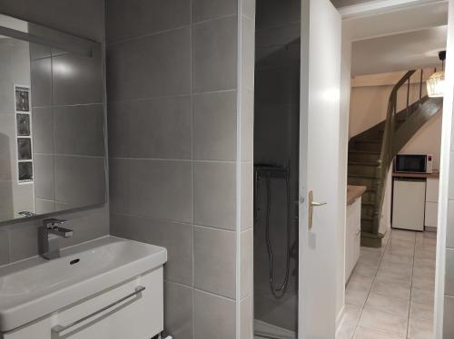 ein Bad mit einer Dusche und einem Waschbecken in der Unterkunft la maison du bonheur in Alençon