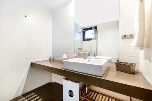 a white bathroom with a sink and a mirror at Fabulous GREEN 19 entre mar y montaña in Bonmont Terres Noves