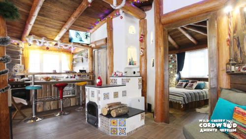 a living room with a fireplace in a log cabin at Wild Cherry Cordwood / Дивите череши in Godech