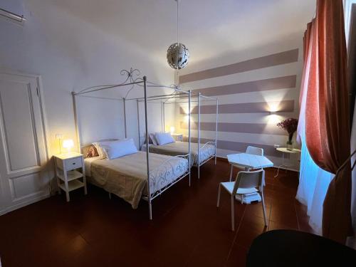 a bedroom with a canopy bed and a chair at B&B Dante Alighieri in Florence
