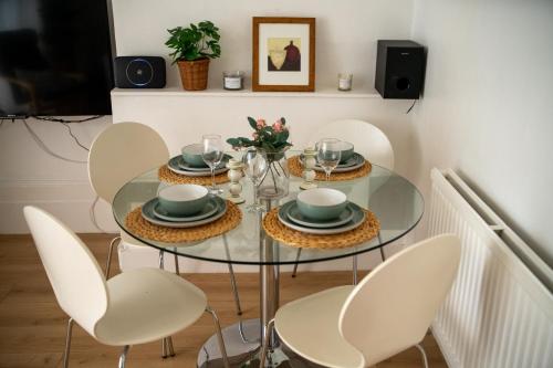a dining room table with chairs and a glass table at Please do not book in London