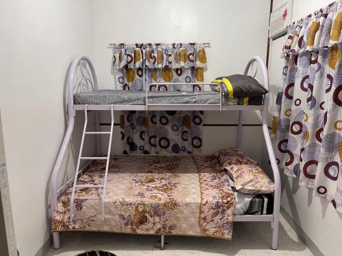 a bunk bed in a room with a shelf at The Tamarind Tree in Puerto Princesa City