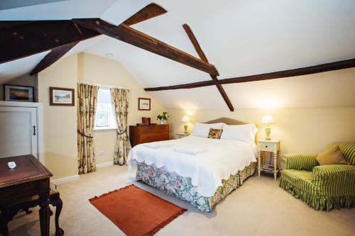 um quarto com uma cama grande e um sofá em The Bothy at Oak Farm em Usk