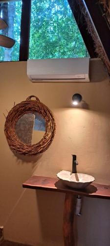 a bathroom with a sink and a mirror on the wall at 7 CIELOS BACALAR. in Bacalar