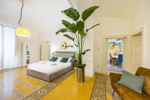 a bedroom with a bed and a potted plant at Kea Home, entire house in the heart of Naples in Naples