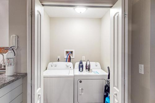 a small laundry room with a washer and dryer at Leisure Lake in Oakland