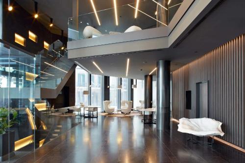 a lobby with chairs and tables in a building at Olivia Balmes Hotel in Barcelona
