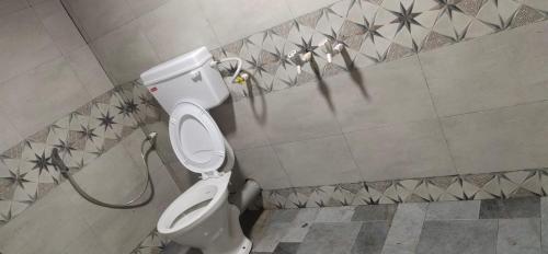 a bathroom with a white toilet in a room at Bungalow resort panorama matheran in Matheran