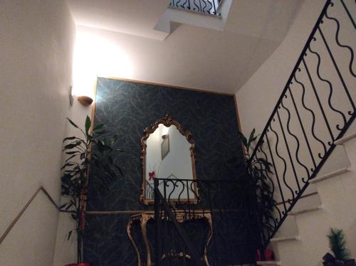 a mirror on a wall next to a staircase at B&B Mini Hotel Incity-close train station and port- in Salerno