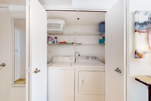 a laundry room with a washer and dryer at East Pass Towers 302 in Destin