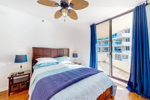 a bedroom with a bed and a large window at East Pass Towers 302 in Destin