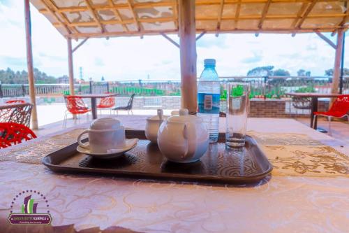 a tray with a tea set on a table at Amicus Hotel Kampala in Kireka