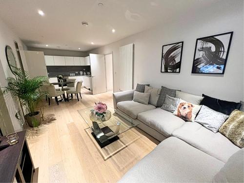 a living room with a couch with a dog on it at Stylish Apartment Docklands in London