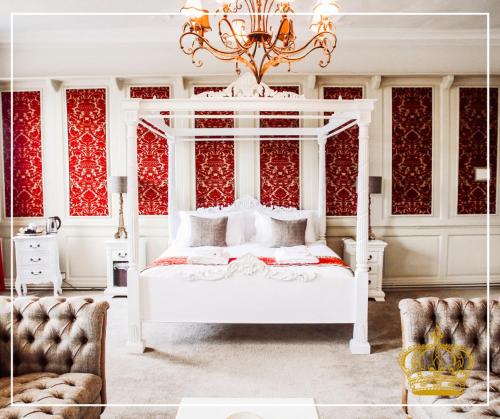 a bedroom with a white bed and a chandelier at The Old Crown Coaching Inn in Faringdon