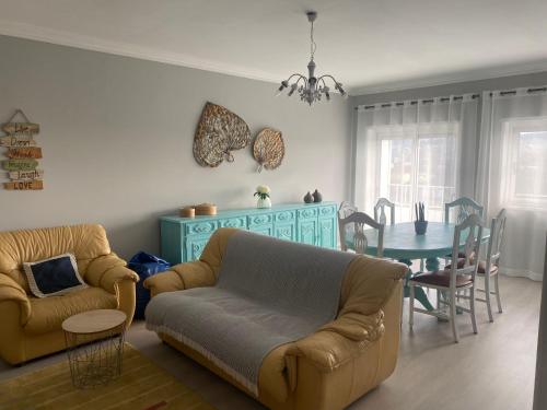 a living room with a couch and a table at O Ninho 94 in Vila Praia de Âncora