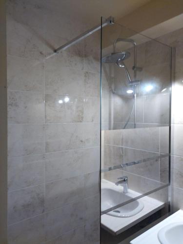 une salle de bain avec une douche en verre avec un lavabo dans l'établissement Charmant Studio Centre Port du Cap d'Agde, au Cap d'Agde