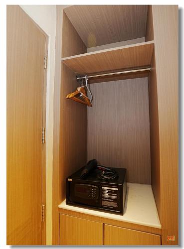a toaster oven sitting inside of a closet at pristine 1 in Manila