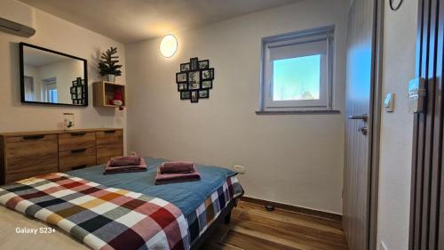 a bedroom with a bed with two towels on it at Apartmaji STARS in Mavčiče