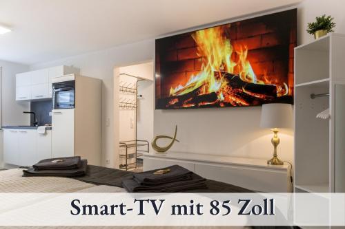 a living room with a fire on the wall at RelaxApartment 1 Massagesessel SmartTV Küche in Biberach an der Riß