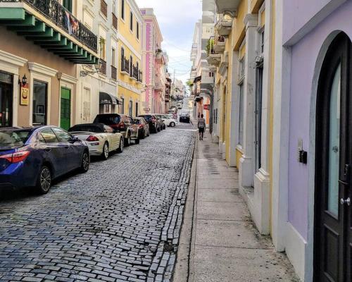 a cobblestone street with cars parked on both sides at KASA The Lofts 304 in San Juan