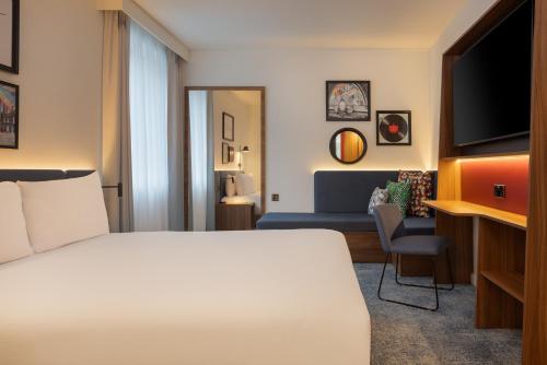 a hotel room with a bed and a tv at Hampton by Hilton London Waterloo in London