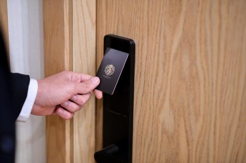 a man is unlocking a door with a passport at Arabella Premium Residence - New Cairo in Cairo