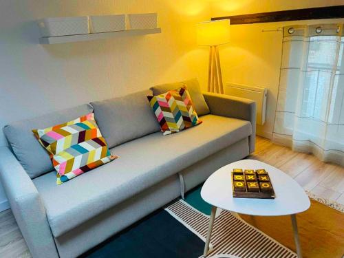 a living room with a couch and a table at Le Grand Studio in Castres