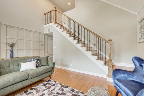 a living room with a couch and a staircase at Brenham Rental with Deck and Yard Less Than 1 Mi to Downtown! in Brenham