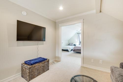 a living room with a flat screen tv on the wall at Brenham Rental with Deck and Yard Less Than 1 Mi to Downtown! in Brenham