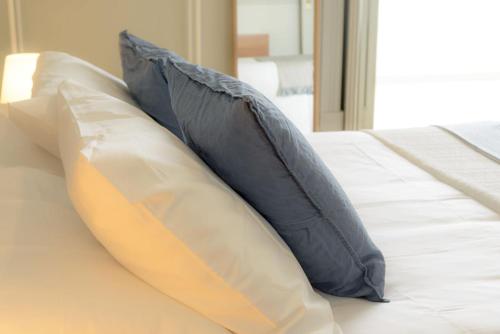 a bed with two pillows on top of it at Lisbon Evergreen Apartment in Lisbon