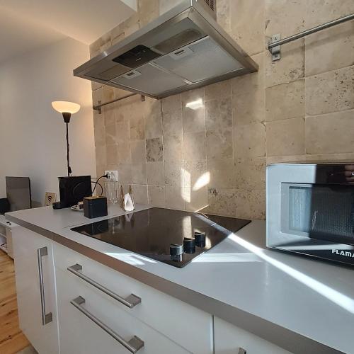a kitchen with a microwave and a counter top at Tomarhousing - Style in Tomar