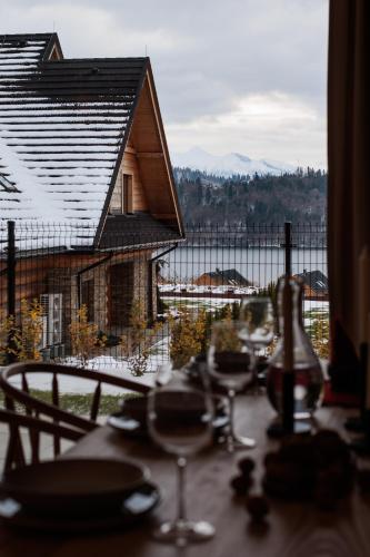 a table with wine glasses on it with a view at Stylchyn Park - Czorsztyn Exclusive - by Upstairs in Kluszkowce