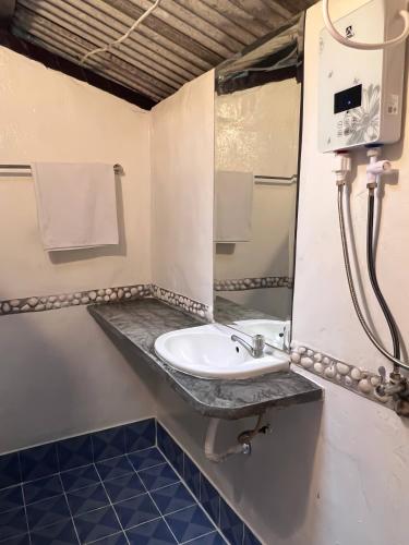 a bathroom with a sink and a mirror at Ko Phangan Haad Yao Beach Hotel in Haad Tian