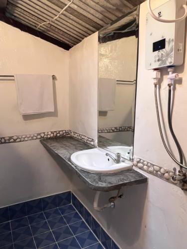 a bathroom with a sink and a mirror at S Place Haad Yao in Haad Tian