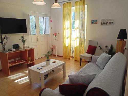 a living room with a couch and a table at Smaragdas Paradise in Hydra