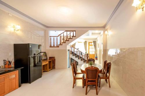 a kitchen and dining room with a table and chairs at LaMay Homestay in Da Lat